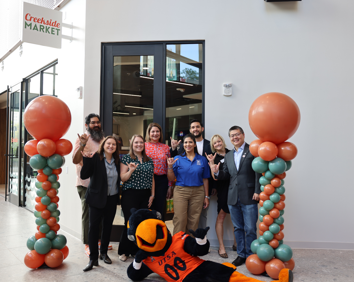 Team members at the grand opening of a location on the campus of UTSA.